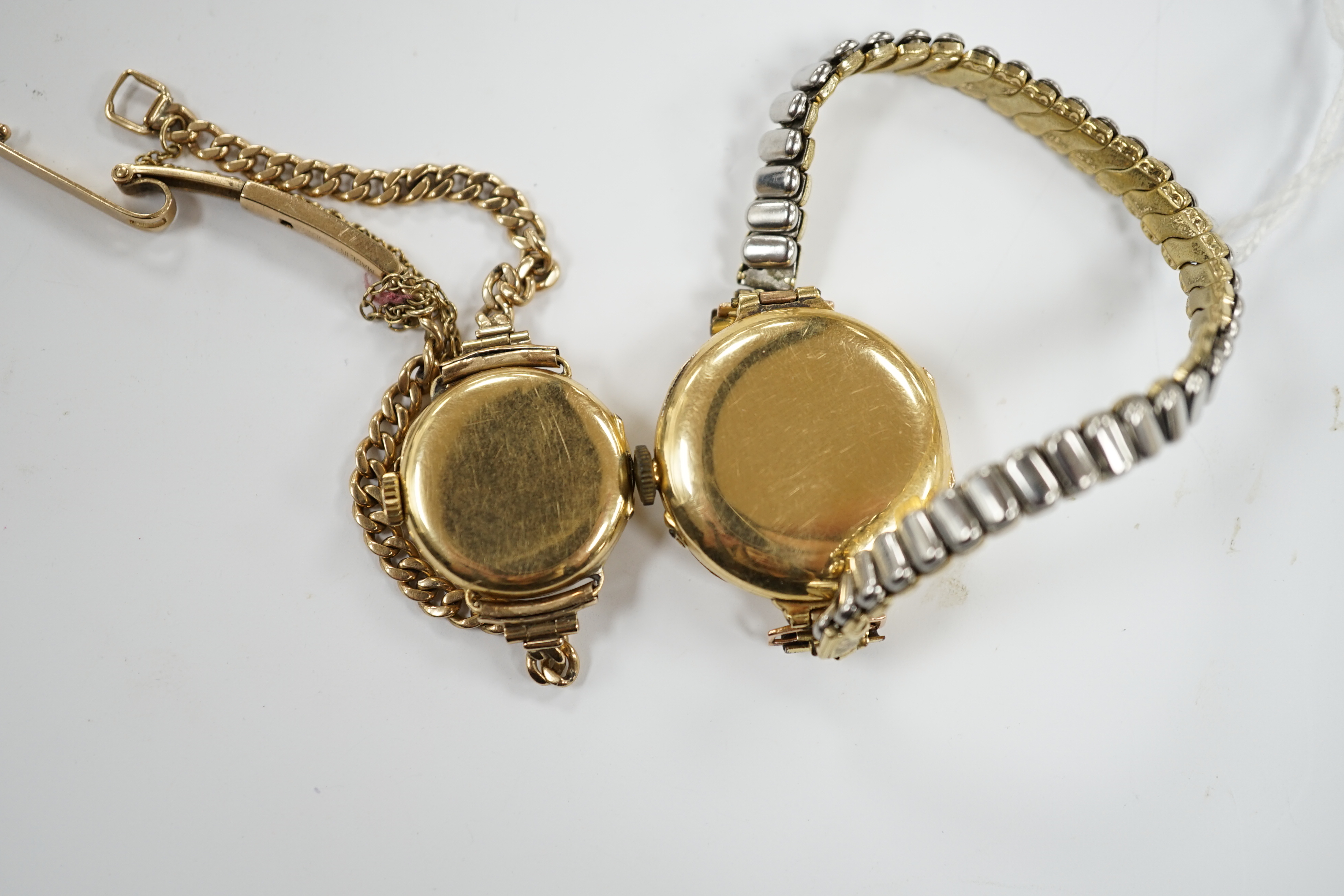 A lady's early to mid 20th century 18ct gold manual wind wrist watch on a 9ct bracelet, together with one other similar 18ct gold manual wrist watch, on a flexible gold plated flexible bracelet.